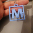 M W keychain logo flexible twisted image