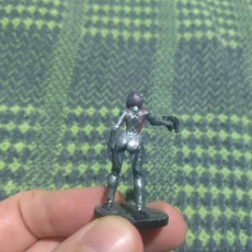 Picture of print of Droid android robot woman with pistol. Sci-fi miniature