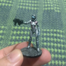 Picture of print of Droid android robot woman with pistol. Sci-fi miniature