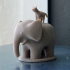 Elephant with a cat on its back image
