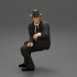 2 Models - businessman in hat sitting and holding briefcase of money image