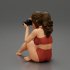 Woman photographer in bikini sitting and holding a camera image
