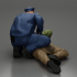 policeman officer sitting and puts handcuffs on a gangster lies on the floor image
