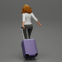 2 Business woman in shirt and trousers pulling suitcase walking in airport terminal image