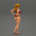Fit hot woman in bikini taking off swimsuit panties on the beach image