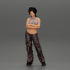 A chola girl with curly hair standing in large pants with crossed hands image