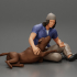 young man in a bonnet sitting crossing his legs and hugging a dog image