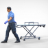 N1 Ambulance worker pulling wheeled stretcher or trolley image