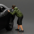 gangster man in a hoodie and shorts shooting a gun behind the car image