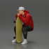 man in hoodie and cap sitting and putting his hand on the skateboard image