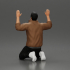 Asian gangster man in jacket sitting with his hands up ready to be arrested image